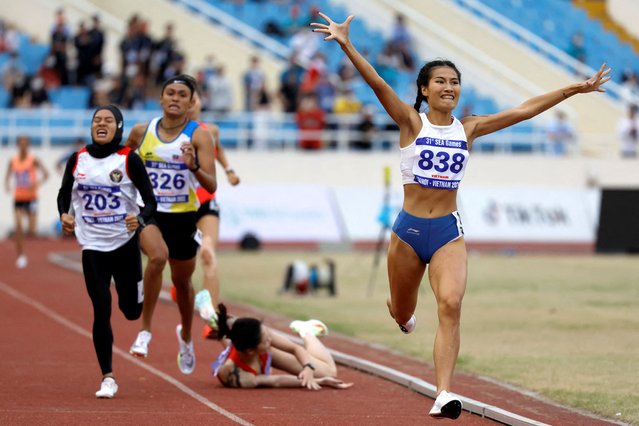 Vietnam's Khuat Phuong Anh (R) celebrates winning the women's 800m final during the 31st Southeast Asian Games (SEA Games) at My Dinh National Stadium in Hanoi on May 16, 2022. (Photo by Navesh Chitrakar/Reuters)