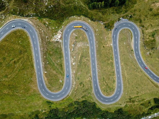 A drone view shows traffic in the curves of the Julierpass road in Surses near Saint-Moritz, Switzerland on September 4, 2024. (Photo by Denis Balibouse/Reuters)