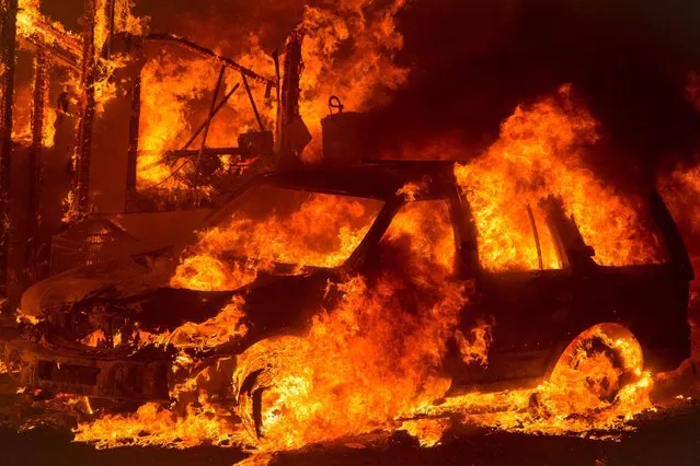 A car is engulfed in flames as the “Wall Fire” burns through a residential area in Oroville, California on July 8, 2017. The first major wildfires after the end of California' s five- year drought raged across the state on July 8, as it was gripped by a record- breaking heatwave. (Photo by Josh Edelson/AFP Photo)