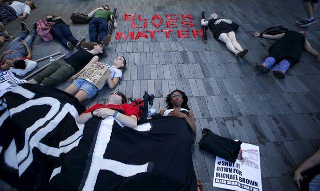 Protesters perform a “die-in” while they take part in a rally at Barclays Center marking the first anniversary of the death of Michael Brown, in Brooklyn, New York August 9, 2015. (Photo by Eduardo Munoz/Reuters)