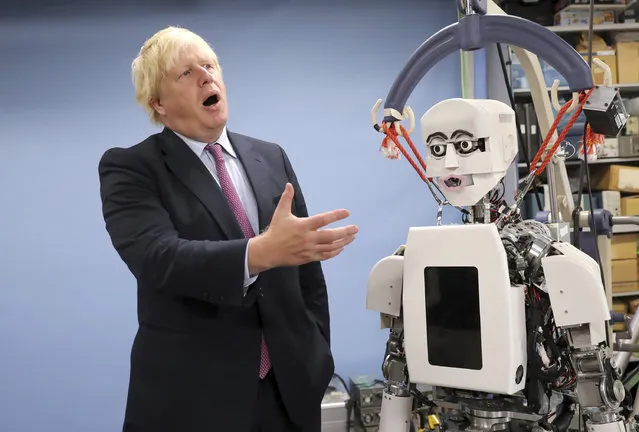 Britain's Foreign Secretary Boris Johnson gestures as he looks at a humanoid robot at Research Institute for Science and Engineering at Waseda University's campus in Tokyo Thursday, July 20, 2017. Johnson visited the robotics center at the university, which collaborates with the University of Birmingham, according to Britain's Foreign and Commonwealth Office. (Photo by Eugene Hoshiko/AP Photo)