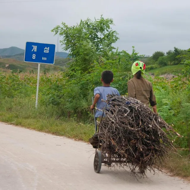 Most of the time people use the highway for their daily activities and are surprised to see cars or buses on it. (Photo by Eric Lafforgue/Exclusivepix Media)