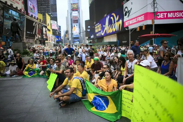 Demonstrators attend a protest against Brazil's President Dilma Rousseff at Times Square in New York August 16, 2015. (Photo by Eduardo Munoz/Reuters)