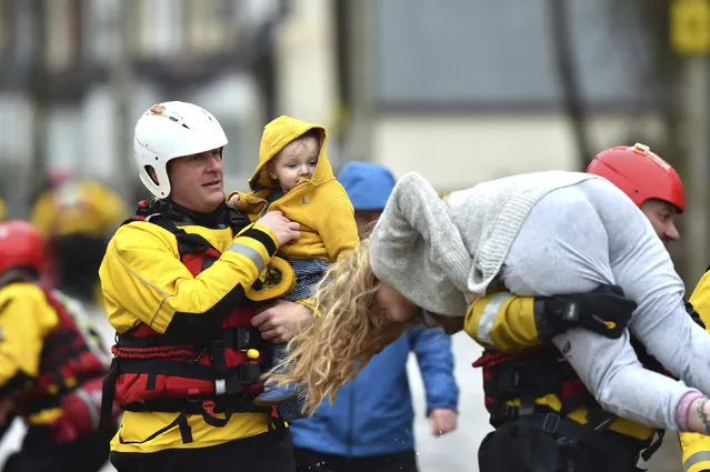 Rescue operations continue as emergency services take families to safety, after flooding in Nantgarw, Wales, Sunday, February 16, 2020. Storm Dennis roared across Britain on Sunday, lashing towns and cities with high winds and dumping so much rain that authorities urged residents to protect themselves from “life-threatening floods” in Wales and Scotland. (Photo by Ben Birchall/PA Wire via AP Photo)