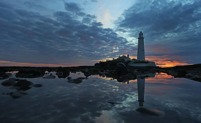 The sky at dawn above St Mary’s Lighthouse, as many parts of the country woke to unsettled weather, Whitley Bay, UK on May 16, 2017. (Photo by Owen Humphreys/PA Wire)