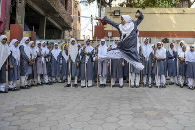 A Muslim girl (C) practices “Vovinam”, a Vietnamese martial art of self-defence by using swords and sticks, to perform for the upcoming International Women's Day as others watch at St Maaz high school in Hyderabad, on March 5, 2020. (Photo by Noah Seelam/AFP Photo)
