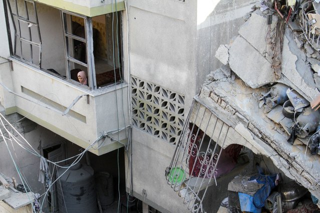 A Palestinian woman looks out of a house damaged in an Israeli strike, amid the ongoing conflict between Israel and Hamas, in Gaza City on November 21, 2024. (Photo by Mahmoud Issa/Reuters)