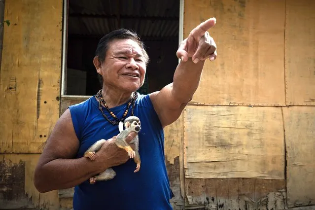 João Bosco Fernandes Sampaio, 61, of the indigenous Tukano people, is seen with his pet at the Yawarité Ipixuna community in Manaus, Amazonas, Brazil, 15 August 2022. The Brazilian indigenous peoples began to be surveyed this month in the framework of the new national census, which is being carried out in the country after twelve years. (Photo by Raphael Alves/EPA/EFE)
