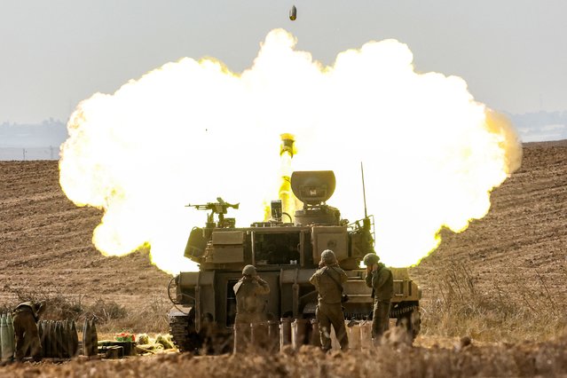An Israeli army self-propelled howitzer fires rounds near the border with Gaza in southern Israel on October 11, 2023. Israel declared war on Hamas on October 8 following a shock land, air, and sea assault by the Gaza-based militant group. The death toll in Israel has surged above 1,200 following the worst attack in the country's 75-year history, while Gaza officials have reported 1000 people killed so far. (Photo by Jack Guez/AFP Photo)