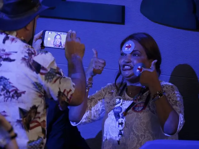 A delegate with Hillary Clinton stickers on her face sits for a video at the Democratic National Convention in Philadelphia, Pennsylvania, U.S. July 27, 2016. (Photo by Gary Cameron/Reuters)