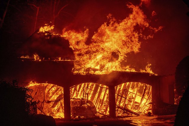 The Eaton Fire burns a residence Wednesday, January 8, 2025 in Altadena, Calif. (Photo by Ethan Swope/AP Photo)