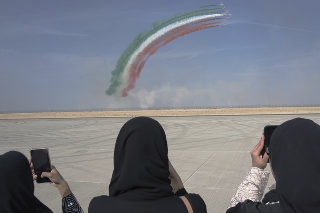 Emirati women film a show by the Italian air force's Frecce Tricolori at the Dubai Air Show in Dubai, United Arab Emirates, Wednesday, November 15, 2023. (Photo by Jon Gambrell/AP Photo)