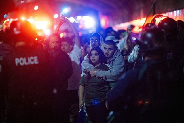 Police detain demonstrators as they are escorted out during an immigration rights protest Monday, February 3, 2025, in Los Angeles. (Photo by Ethan Swope/AP Photo)