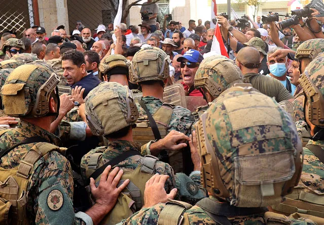 Lebanese army soldiers clash with retired military personnel as they try to break into the parliament in Beirut on September 26, 2022, during a session to approve the 2022 budget. (Photo by Anwar Amro/AFP Photo)