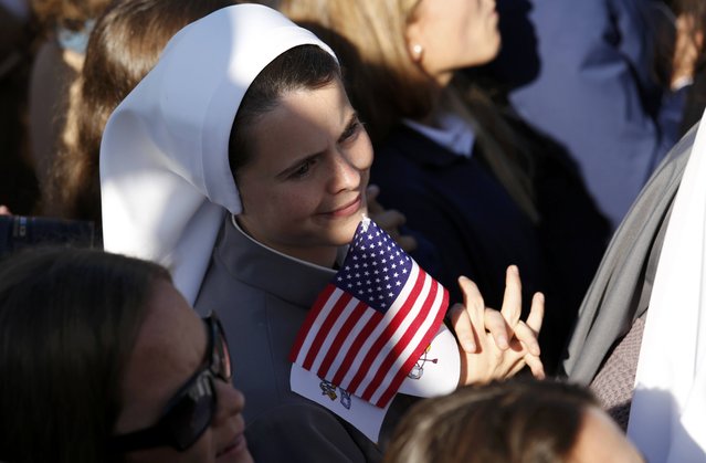 A nun holds a U.S. flag during an arrival ceremony for Pope Francis at the White House in Washington September 23, 2015. The pontiff is on his first visit to the United States. (Photo by Kevin Lamarque/Reuters)