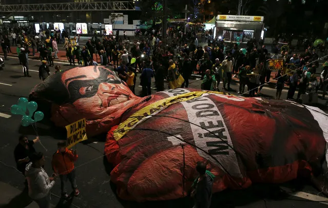 An inflatable doll in the image of Brazil's former president Dilma Rousseff is pictured as people celebrate after Brazil's Senate removed Rousseff, along Paulista Avenue at the financial district in Sao Paulo, Brazil, August 31, 2016. (Photo by Paulo Whitaker/Reuters)