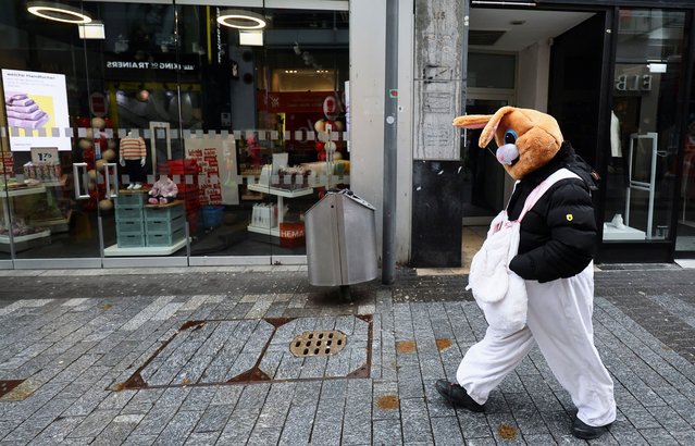 A reveller in a rabbit costume walks during a celebration of “Weiberfastnacht” (Women's Carnival), marking the start of the street Carnival festivals in Cologne, Germany, on February 8, 2024. (Photo by Wolfgang Rattay/Reuters)