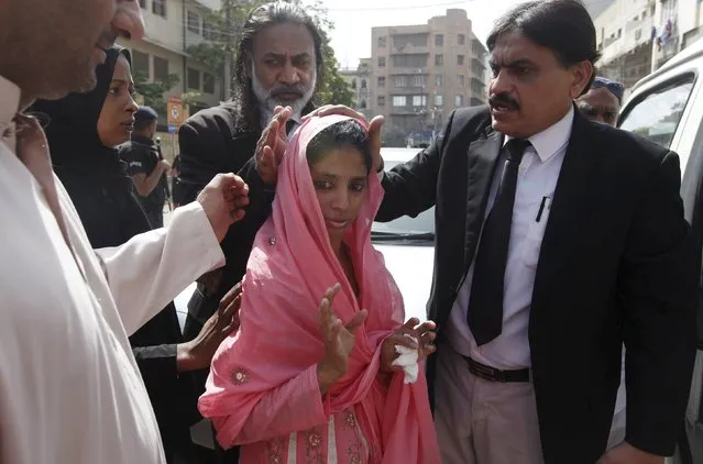 Geeta (C) walks with lawyers after a case hearing outside district City court in Karachi, Pakistan, September 3, 2015. A Pakistani court on Thursday rejected a petition to send back to India Geeta, a deaf-mute woman who lost her family when she wandered over one of the world's most militarised borders as a child, saying the two nations should resolve the issue diplomatically. (Photo by Akhtar Soomro/Reuters)
