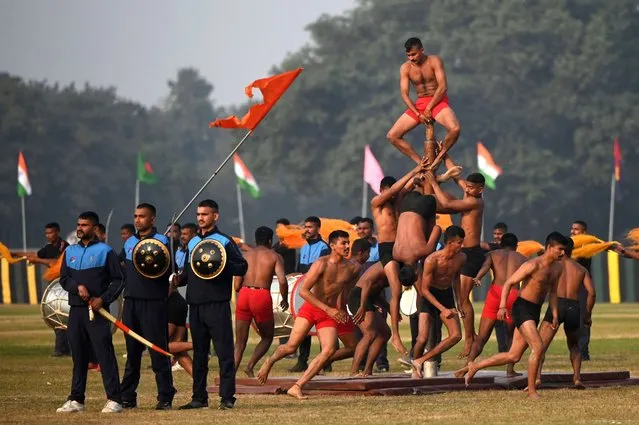 Indian Army officials perform during the final rehearsal ahead of Indian Army “Vijay Diwas” celebrations, at the Royal Calcutta Turf Club (RCTC) in Kolkata on December 14, 2022. “Vijay Diwas” is celebrated every year on December 16 to honour the victory of Indian armed forces over Pakistan in the 1971 Bangladesh liberation war. (Photo by Dibyangshu Sarkar/AFP Photo)