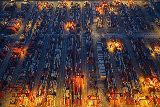 An aerial view shows containers stacked at a port in Taicang, in eastern China's Jiangsu province on May 18, 2025. (Photo by AFP Photo/China Stringer Network)