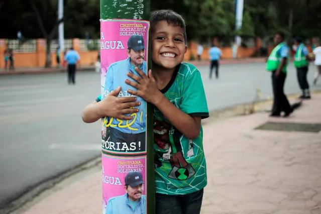 A child embraces a poster of Nicaragua's President Daniel Ortega during Independence Day celebrations in Managua, Nicaragua September 14, 2016. (Photo by Oswaldo Rivas/Reuters)