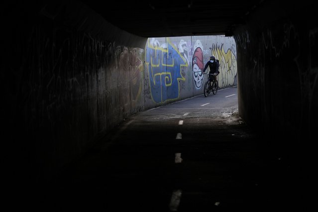 A commuter cycles along an empty street on the city's annual car-free day in Bogota, Colombia, Thursday, February 6, 2025. (Photo by Fernando Vergara/AP Photo)