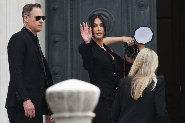 American socialite Kim Kardashian waves as she arrives to testify regarding a robbery of millions of dollars in jewels from her Paris hotel room in 2016, in Paris, Tuesday, May 13, 2025. (Photo by Aurelien Morissard/AP Photo)