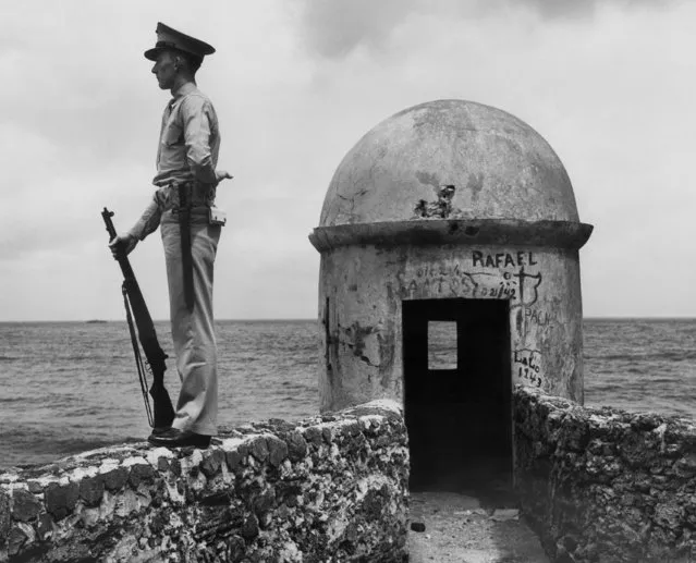 Pfc. Joseph A. Hartman, USMC, of Philadelphia Pennsylvania, stands guard watch beside the haunted sentry tower of Fort San Cristobel in Puerto Rico  December 29, 1943. The famous fortress was built of hand-turned stone by the Spaniards of the 16th century. (Photo by AP Photo)