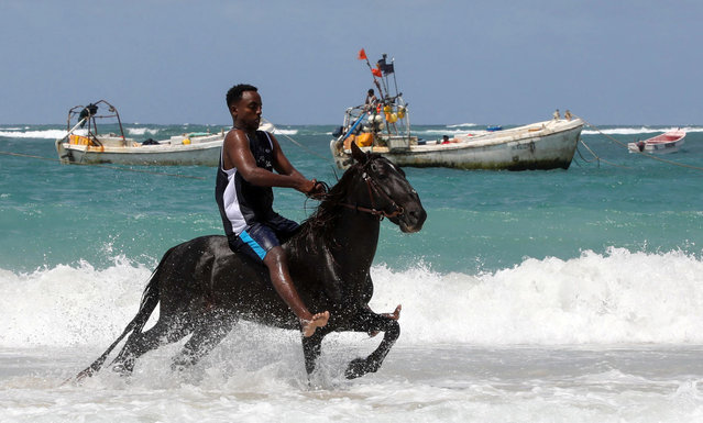 A man rides a horse in the water on Liido beach in Abdiaziz district, Mogadishu, Somalia, on June 2, 2025. (Photo by Feisal Omar/Reuters)