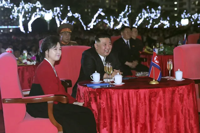 This photo provided by the North Korean government shows North Korean leader Kim Jong Un, center, and his wife Ri Sol Ju, left, watch a performance during a celebration marking the nation's 74th anniversary in Pyongyang, North Korea, on September 8, 2022. Independent journalists were not given access to cover the event depicted in this image distributed by the North Korean government. The content of this image is as provided and cannot be independently verified. (Photo by Korean Central News Agency/Korea News Service via AP Photo)