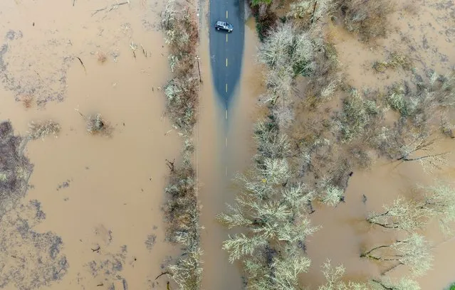 A vehicle turns around on a flooded road in Sebastopol, California, on January 05, 2023. Excessive rain, heavy snow and landslides are expected to wallop California through Thursday as a series of winter storms rip across the western US coast, prompting Governor Gavin Newsom to declare a state of emergency. (Photo by Josh Edelson/AFP Photo)