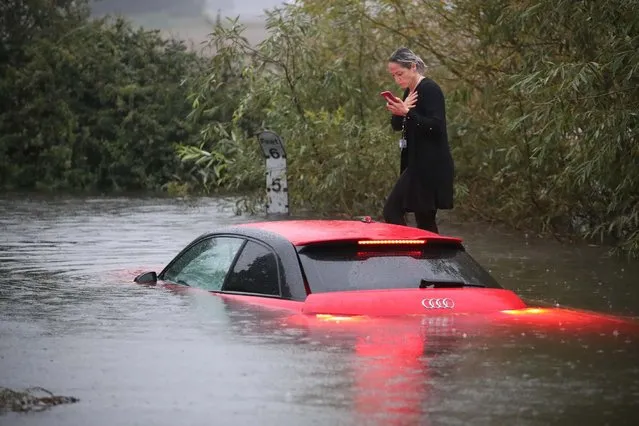 A woman stranded near Ingatestone, Essex, after heavy downpours into a 4ft (122cm) flood on October 3, 2020. Weather warnings are in place for large parts of England, Scotland and Wales on Sunday. (Photo by NC/The Times)