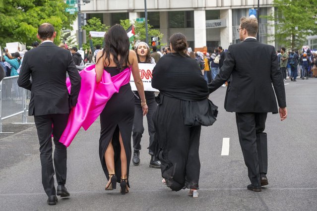 A demonstrator protests as guests arrive at the White House Correspondents Association Dinner at the Washington Hilton on Saturday, April 27, 2024, in Washington. (Photo by Kevin Wolf/AP Photo)