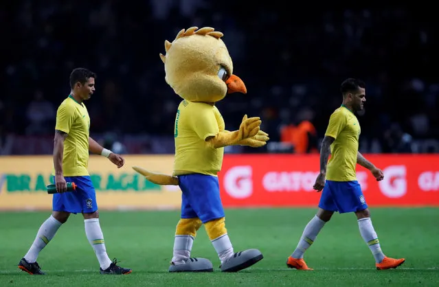 Brazil mascot celebrates on the pitch with Brazil's Thiago Silva and Dani Alves after the match between Germany and Brazil in Berlin, Germany, Tuesday, March 27, 2018. (Photo by Wolfgang Rattay/Reuters)
