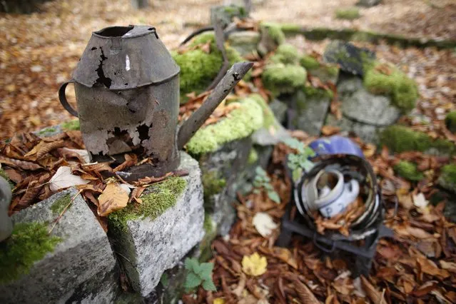 Various items are gathered in the ruins of the church at Perthes-les-Hurlus, a former village of 151 inhabitants in 1914, on the Champagne front near Reims, November 3, 2015. The village is largely covered by woodland now and is located inside the Camp de Suippes. Badly damaged headstones from the pre-war cemetery stand nearby the church. (Photo by Charles Platiau/Reuters)