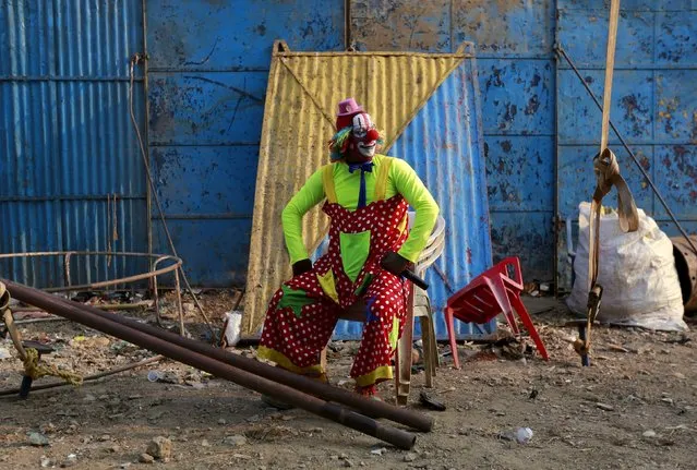 A lead clown waits backstage before a show at the Rambo Circus in Mumbai, India, November 4, 2015. According to Rambo Circus owner Sujit Dilip, the ban on the use of wild animals, the lack of new artists and various restrictions by the government have resulted in the drastic decline of the circus industry in India. (Photo by Danish Siddiqui/Reuters)