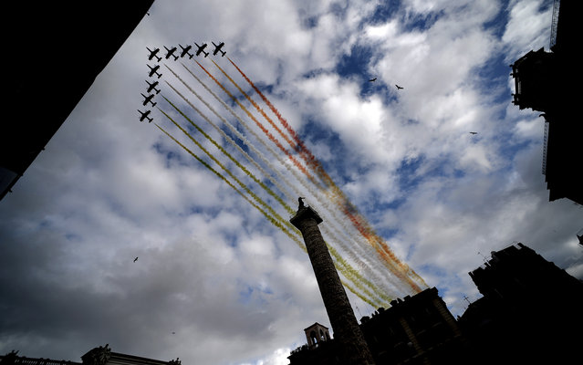 The Frecce Tricolori, aerobatic demonstration team of the Italian Aeronautica Militare, flies over the Altare della Patria (Tomb of the Unknown Soldier) in Rome on April 22, 2013, as the Italian President Giorgio Napolitano attends a ceremony after his re-election. Italy's 87-year-old president prepared to be sworn in for an unprecedented second term, amid hopes of an end this week to a deadlock on forming a new government. Napolitano is due to take his presidential oath in parliament, but the usually grandiose ceremony has been stripped down in line with a sombre mood in times of austerity in Rome. (Photo by Filippo Monteforte/AFP Photo)