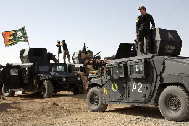 Iraqi special forces soldiers deployed for an offensive to retake Mosul from Islamic State militants prepare to move out from a camp near Khazer, Iraq, on Friday, October 14, 2016. The US-led coalition says they are increasing airstrikes in and around the militant-held city of Mosul as Iraqi ground forces are building up ahead of a planned operation to retake the city. (Photo by Adam Schreck/AP Photo)
