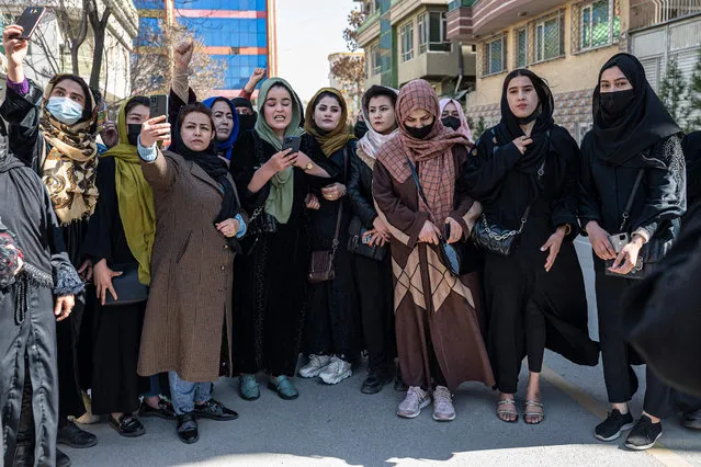 Afghan women stage a protest for their rights to mark International Women's Day, in Kabul on March 8, 2023. (Photo by AFP Photo/Stringer)