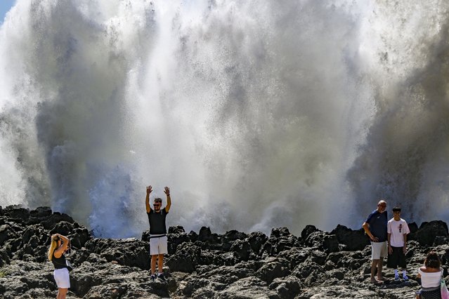 Tourists stand selfing as large waves crash against the cliff in Boca do Inferno on August 26, 2025, in Cascais, Portugal. Six sea coastal areas are closed to navigation today due to strong sea turbulence, which has led the Portuguese Sea and Atmosphere Institute (IPMA) to issue a yellow warning for 10 districts in mainland Portugal. The districts of Porto, Faro, Setúbal, Viana do Castelo, Lisbon, Leiria, Beja, Aveiro, Coimbra and Braga have been under a yellow warning since 6am Tuesday until 6am on Wednesday. (Photo by Horacio Villalobos#Corbis/Corbis via Getty Images)