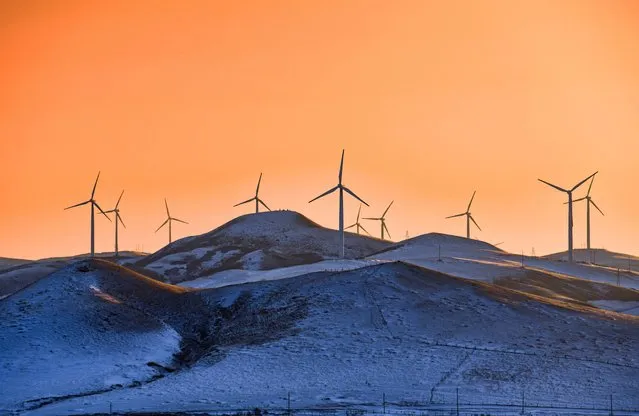 Wind turbines stand on a snowfield on February 23, 2023 in Tongliao, Inner Mongolia Autonomous Region of China. (Photo by Wang Zheng/VCG via Getty Images)
