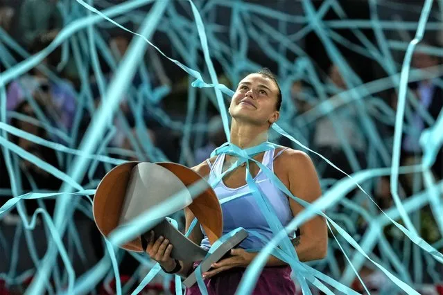 Belarus' Aryna Sabalenka holds the winner's trophy after defeating Iga Swiatek of Poland at the end of the women's final at the Madrid Open tennis tournament in Madrid, Spain, Saturday, May 6, 2023. (Photo by Manu Fernandez/AP Photo)