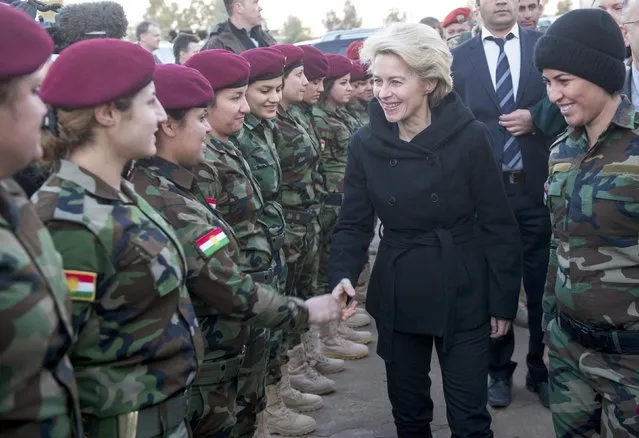 German Defence Minister Ursula von der Leyen (2nd R) greets Kurdish forces female recruits at the Zeravani Training Centre in Bnaslava near Arbil, north of Iraq January 12, 2015, who are being trained by the German armed forces, Bundeswehr. (Photo by Maurizio Gambarini/Reuters)