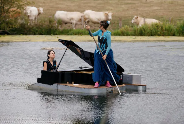 Pianist Cecile Wouters and singer Evelyne Zou perform on a lake during a rehearsal of their show “Melting Flotte” at the Chateau de Ricquebourg in Ricquebourg, France on July 24, 2020. (Photo by Pascal Rossignol/Reuters)