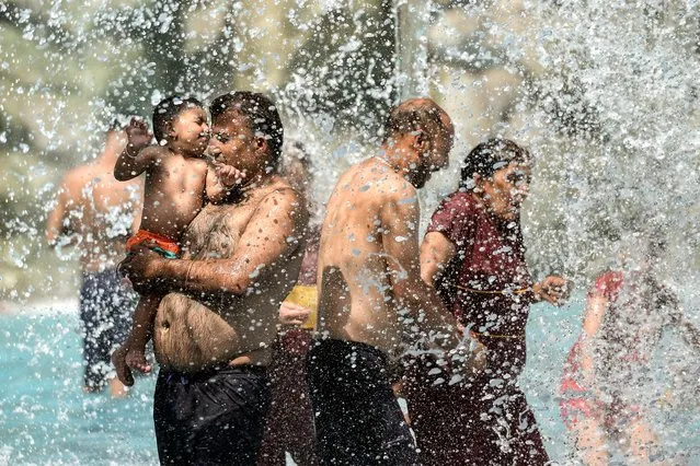 People enjoy at a waterpark on a hot summer day in Jalandhar on May 15, 2023. (Photo by Shammi Mehra/AFP Photo)