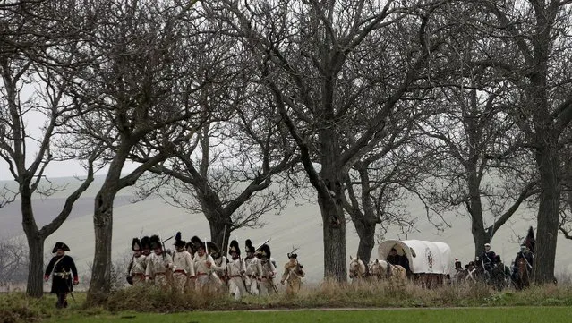 Historical re-enactment enthusiasts dressed as soldiers march near the southern Moravian village of Herspice December 4, 2015. (Photo by David W. Cerny/Reuters)