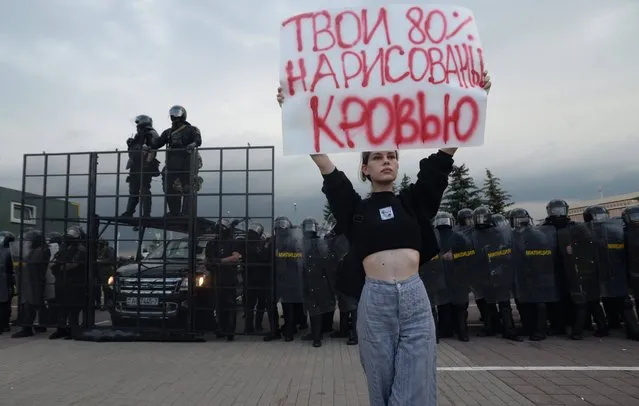 A woman holds a poster “Your 80 percent are painted with blood” during a protest rally against the results of the presidential elections, in Minsk, Belarus, 30 August 2020. Opposition protests in Belarus continue against alleges poll-rigging and police violence at protests following election results claiming that president Lukashenko had won a landslide victory in the 09 August elections. (Photo by EPA/EFE/Stringer)