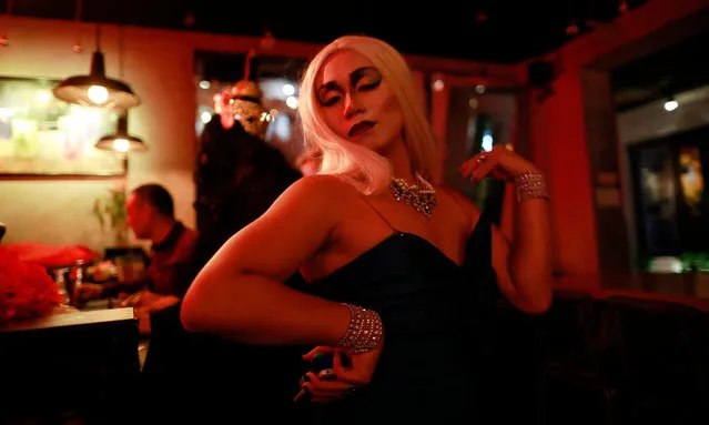 Drag queen Charlie Van de Ho strikes a pose at the bar before their show at Destination night club in Beijing, China, 04 July 2018. Known only by their stage names, Krystal de Canteur, Charlie Van de Ho, Vivian Eastwood and Siberia are part of a group of nine drag queens that have come together this summer to perform weekly at Beijing's gay night club Destination, a first for the capital city to have a regular stage show featuring drag queens. (Photo by How Hwee Young/EPA/EFE)