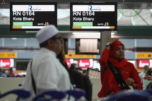 In this December 22, 2015, photo, Muslim travellers queue up in front of Rayani Air's check-in counter at Kuala Lumpur International Airport 2 in Sepang, Malaysia. (Photo by Joshua Paul/AP Photo)