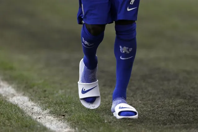 Chelsea's N'Golo Kante walks wearing a pairs of slippers at the end of the English Premier League soccer match between Leeds United and Chelsea at Elland Road stadium, in Leeds, England, Saturday, March 13, 2021. (Photo by Lee Smith/Pool via AP Photo)
